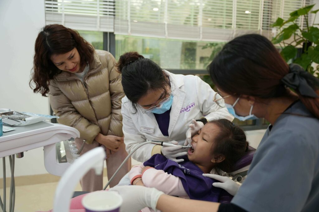 A woman receiving a dental examination from a dentist, highlighting the importance of bone grafting for implants.