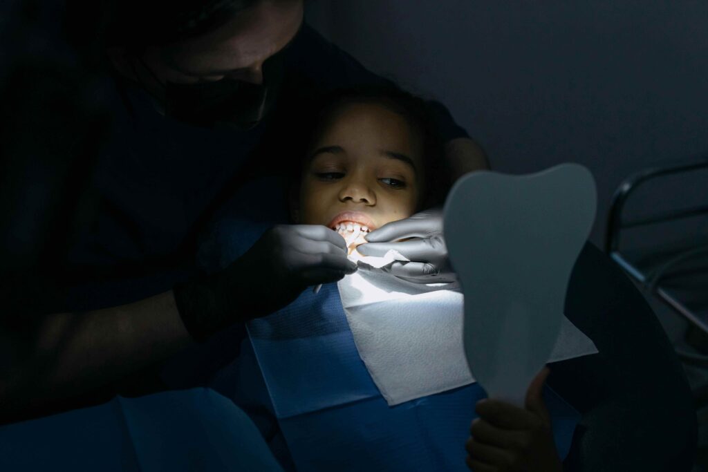 patient in a dental chair with a dentist, emphasizing the role of dental care in cleft lip and palate treatment.