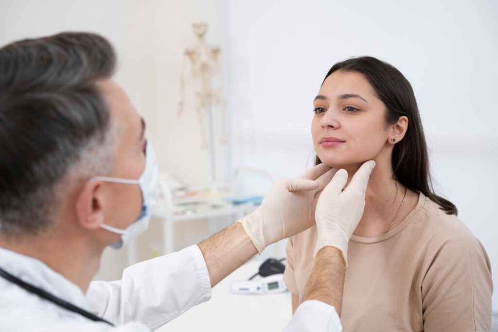 A woman receives a neck check from a doctor in preparation for jaw surgery