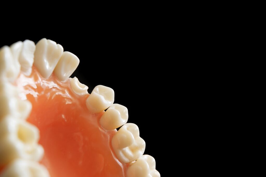 A tooth with a toothbrush placed inside, symbolizing dental care and hygiene in pediatric dentistry.